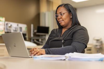 Woman working on laptop at a desk
