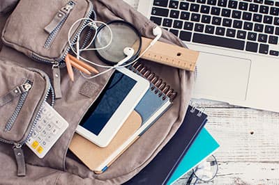 backpack with laptop and school supplies