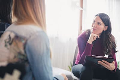 counselor with clipboard talking to someone