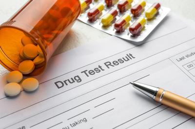 Drug Test Result paperwork with pills