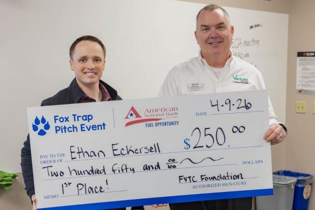 Two men holding a large check for 250 dollars