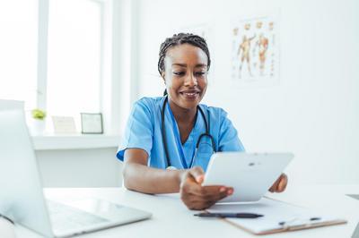 Medical professional reviewing paperwork at desk