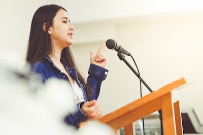 woman standing at podium with microphone