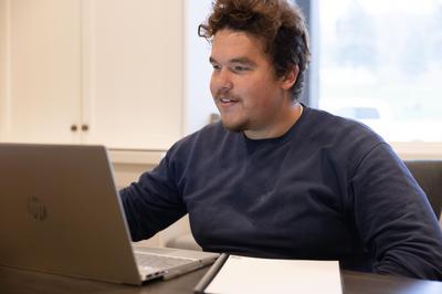 Student working on laptop at desk