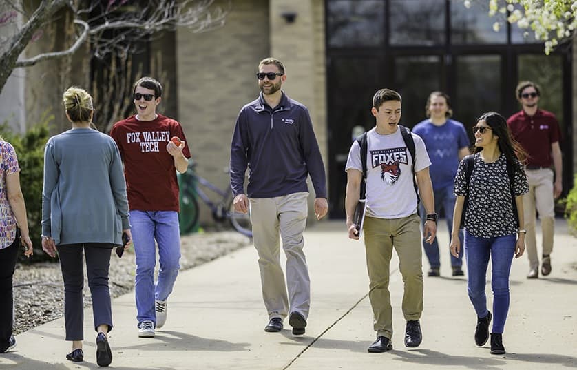 Student shaking hands with teacher