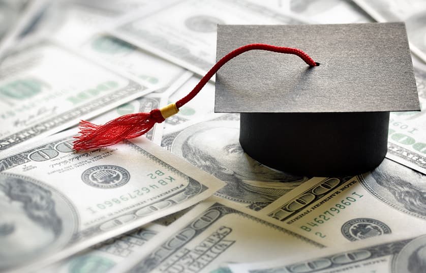 Graduate cap sitting on money