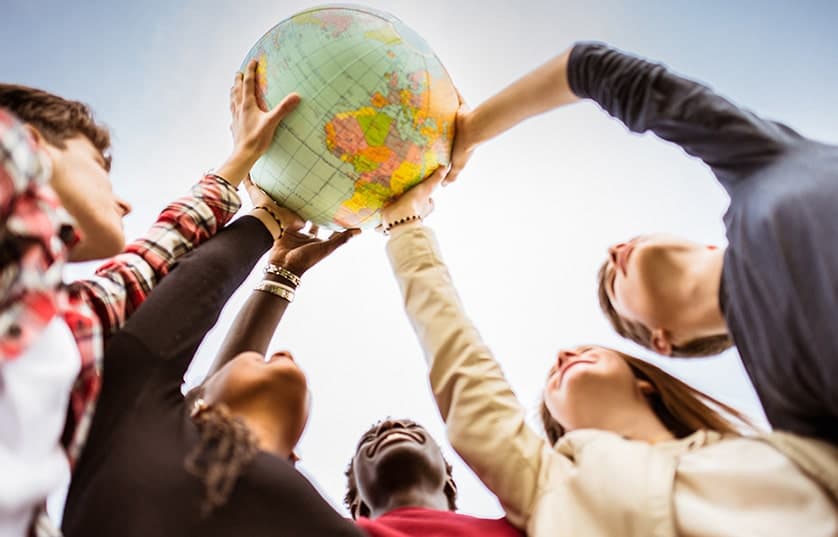 Students holding inflatable globe