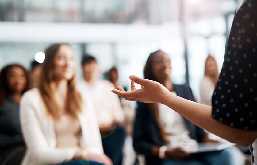 teacher standing in front of class of students