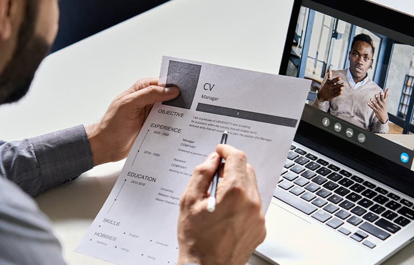 two people with clipboards shaking hands