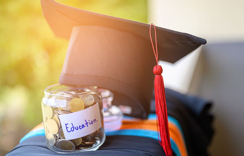 Graduation cap with jar of change