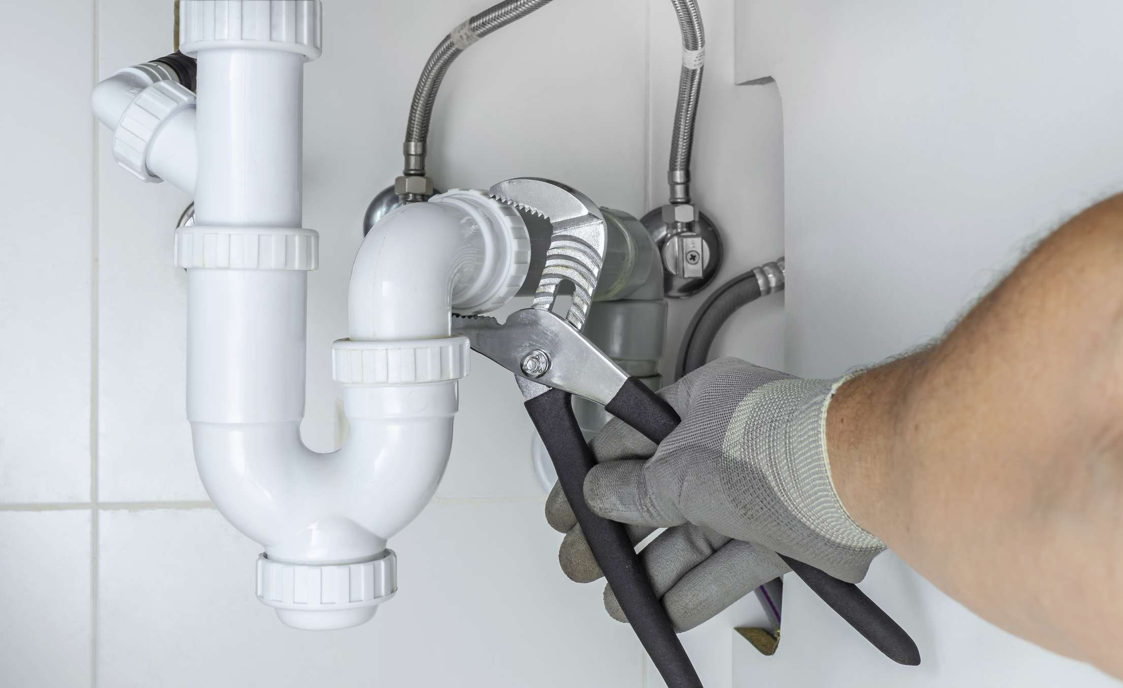 plumber working on pipe