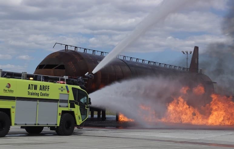 FVTC ARFF Training Center training airplane on fire with striker truck spraying water