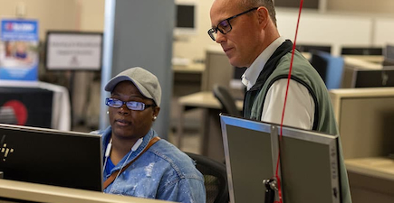 fox valley tech instructor helping a student at a computer