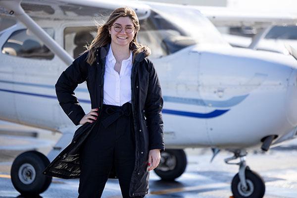 pilot standing outside a small airplane