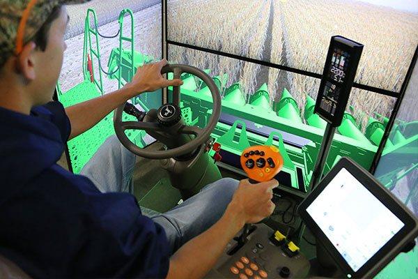 person operating a combine simulator