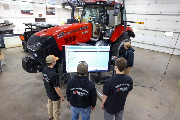 students in an ag power lab with tractor and computer monitor
