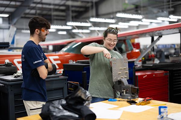 Two FVTC students working on airplane equipment