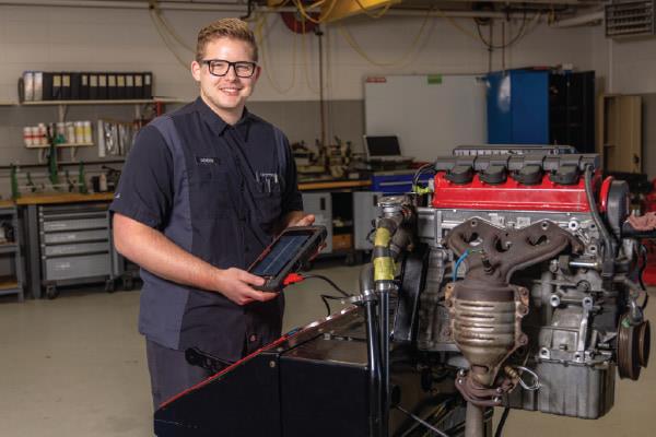 service technicians standing in automotive service shop fixing car on lift