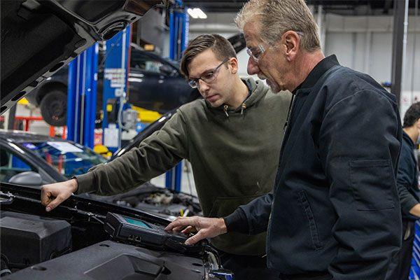 technicians working on an automobile