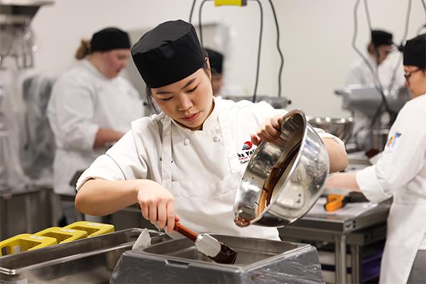 students working in a baking lab making pastries