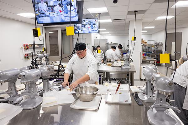 FVTC culinary student in baking lab icing scones