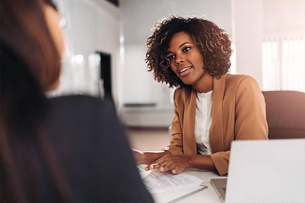 woman working with someone across a desk