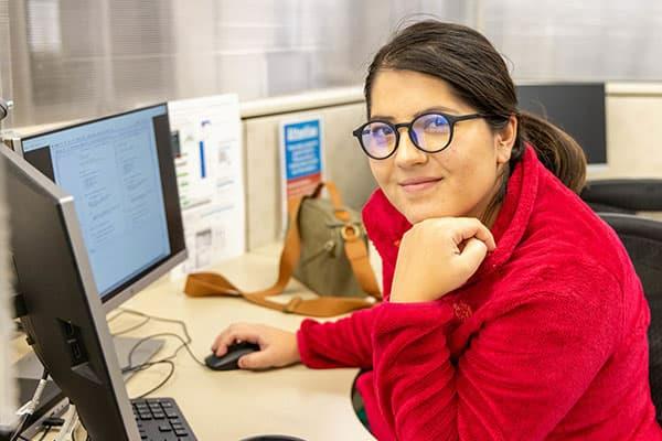 student at a computer working on a class project