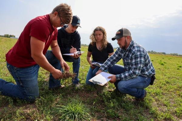 crop application specialist students learning in a field