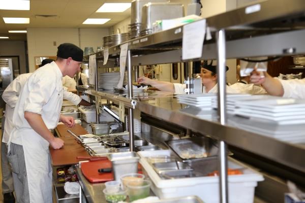 students working a food service line