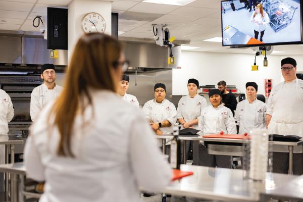 chefs in culinary arts lab preparing a meal