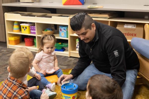 student working with toddlers in early childhood program