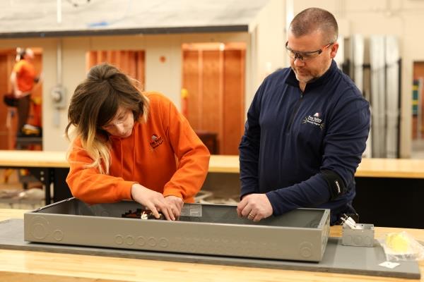 electrician student working in a lab with an instructor