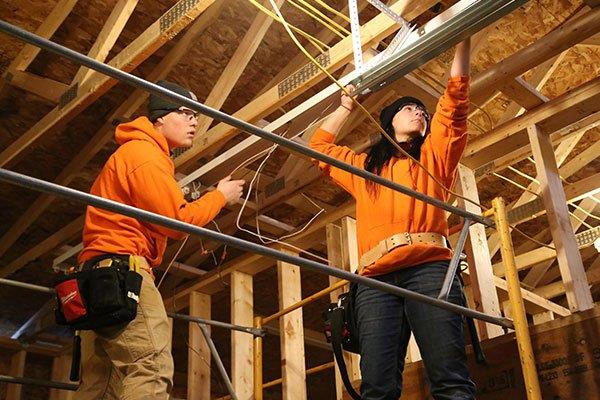 electrical workers wiring building under construction