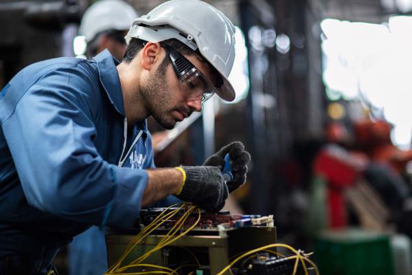 industrial maintenance mechanic working on a piece of equipment