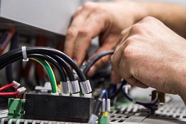 person working with electrical wire panel