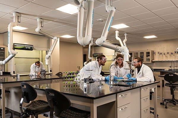 science students wearing safety goggles in lab classroom