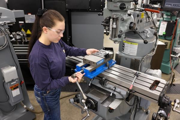 student with safety glasses working in machine tool shop