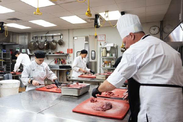 people working in a meat processing plant