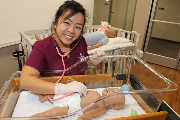 nursing student caring for a baby in a lab