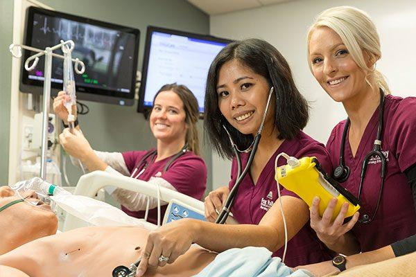 nursing students in lab caring for a patient