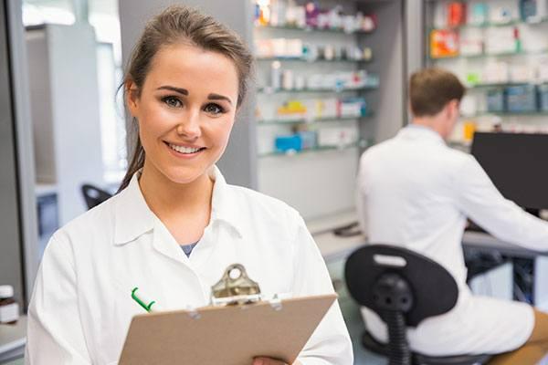 pharmacy services manager with a clipboard and pen