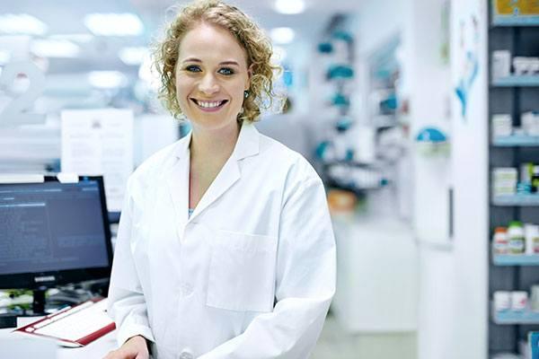a pharmacy technician at work filling prescriptions