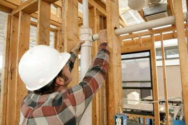pipe trades construction worker in home building