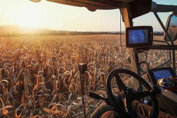 farmer in field using high-tech farm equipment