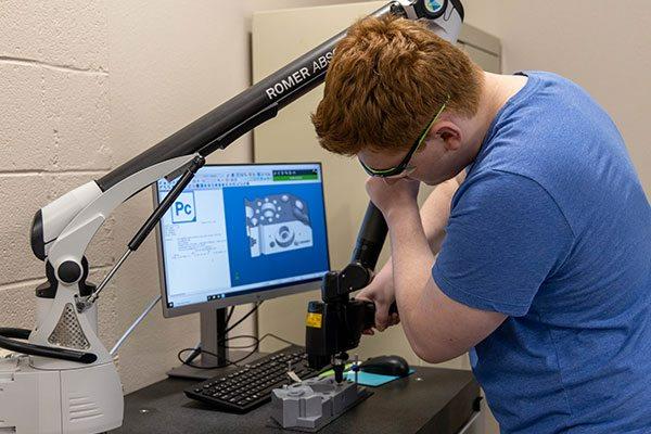 student working on a quality engineering project using technology