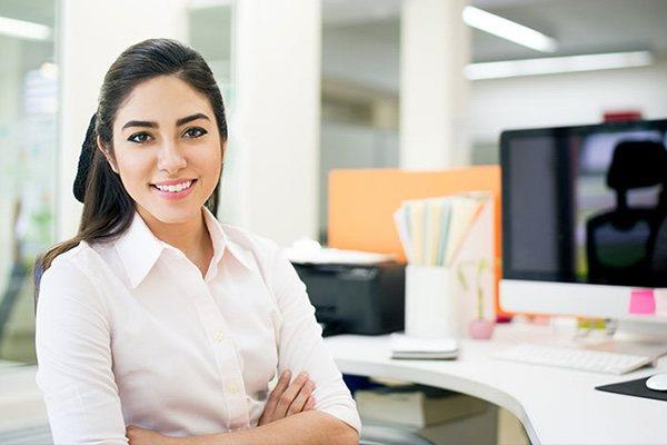 receptionist at desk welcoming clients