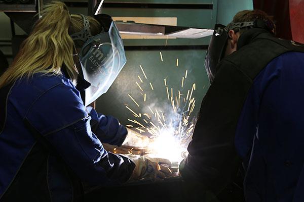 student and instructor working on a welding project