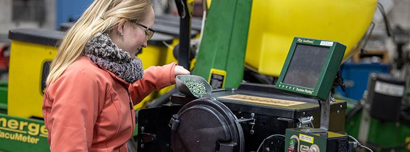 student working on agriculture equipment in school