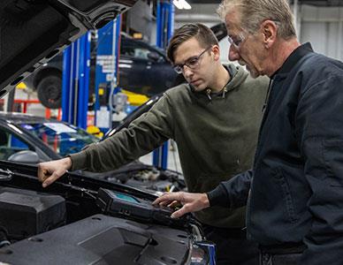 instructor demonstrating auto technology to student