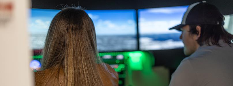 two students in flight simulator